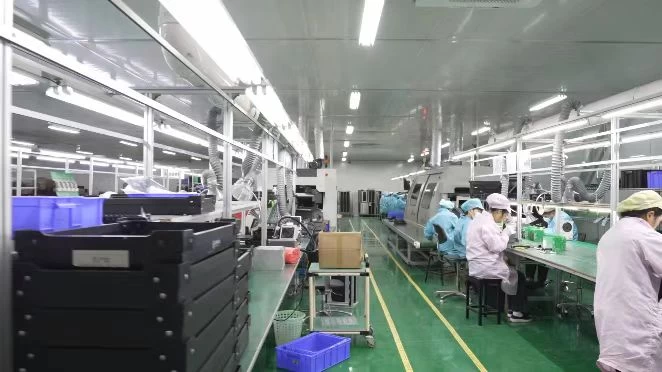 Electronics assembly production line with technicians