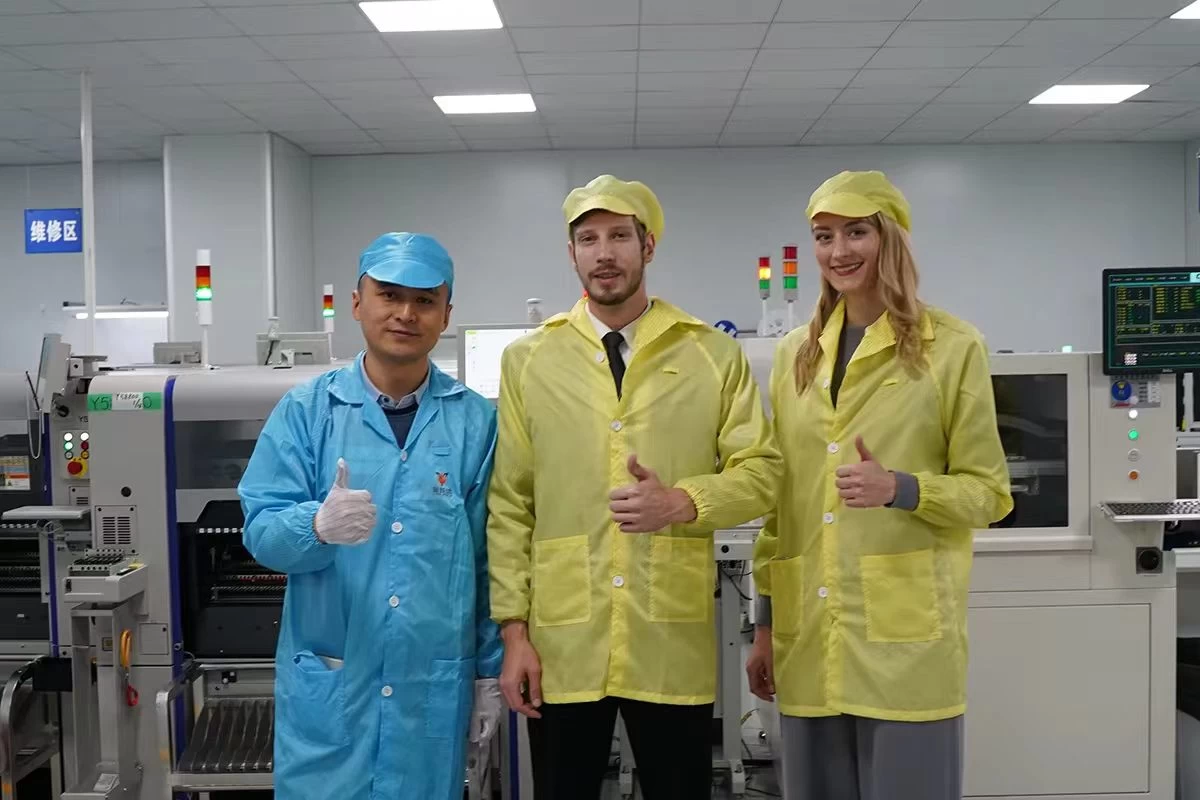 Three people on a production floor