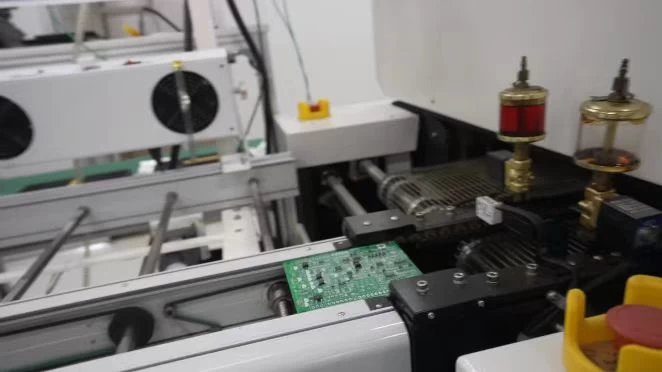Circuit board moving through production equipment