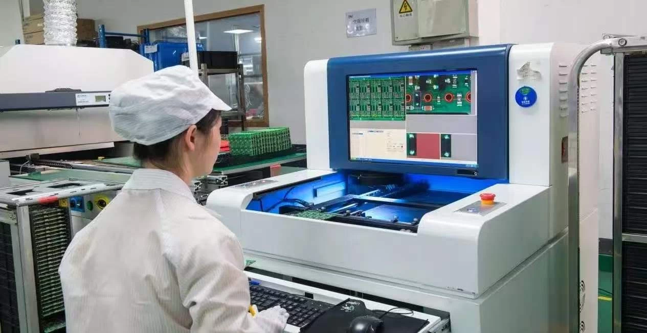 Technician inspecting circuit boards with machine vision system