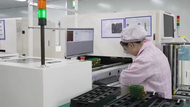 Technician working at automated production equipment