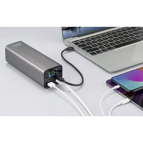 Portable power bank charging a laptop and smartphone